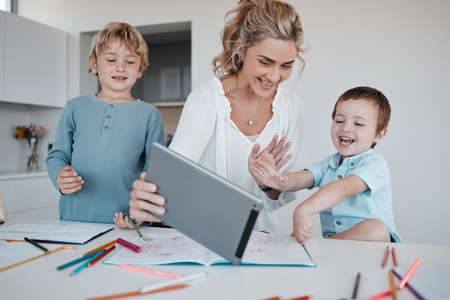 Family on a distance learning video call, learning or teaching online. A happy mother and her little...