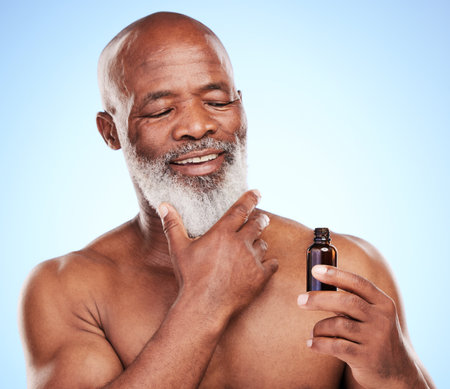 Cropped shot of a handsome mature man posing in studio against a blue background.の写真素材