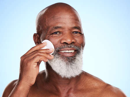 Exfoliation is the key. Cropped portrait of a handsome mature man posing in studio against a blue background.の写真素材
