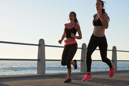 Shot of two attractive young female athletes exercising outdoors.
