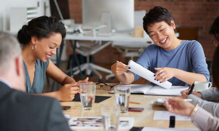 Shot of a group of businesspeople having a meeting in an office.の写真素材