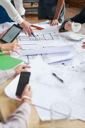 Planning everything with precision and detail. Closeup shot of a group of architects working with...