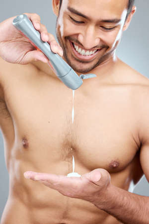 Self-care is simply the act of taking time to focus on yourself. Studio shot of a man squeezing lotion onto his hand.の写真素材