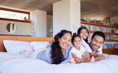 Family bed bonding daughter parent sister baby cute love house. Family bed bonding daughter parent sister baby cute love house.の写真素材