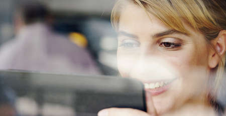 The wifi here is so fast. Cropped shot of an attractive young businesswoman working in a coffee...