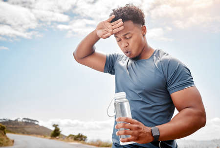 A healthy outside starts from the inside. Shot of a man drinking water while out for a workout.