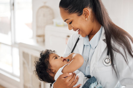 If it isnt my favourite patient. Shot of a pediatrician holding her little patient.の写真素材