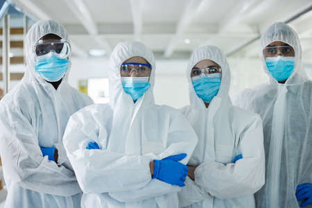 Were on the job. Shot of a group of scientists standing with their arms crossed at a lab.の写真素材