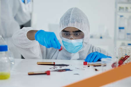 What a disaster. Shot of a young scientist cleaning up a mess at a lab.