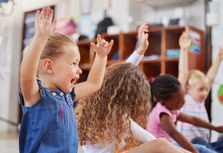 Im always excited to come to class. Shot of a group of children sitting in class.の写真素材