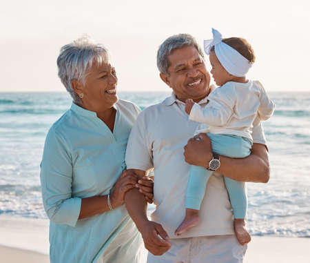 Grandchildren bring so much happiness into our lives. Shot of a senior couple at the beach with their adorable granddaughter.の写真素材
