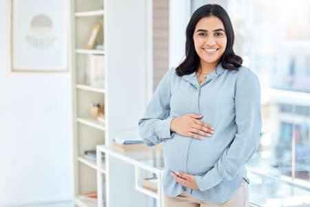 Im excited for this new chapter. Portrait of a pregnant businesswoman working in an office.