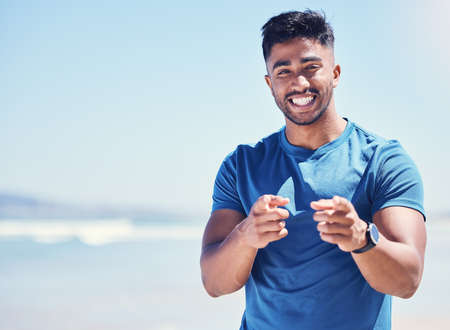 Youll be doing yourself a favour. Shot of a fit young man out for a workout on the beach.の写真素材