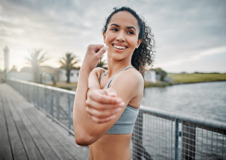Cropped shot of an attractive young female athlete warming up before her morning run outside.