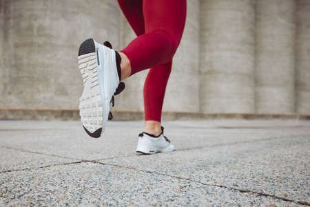 Always moving. Rearview shot of an unrecognizable female athlete running outdoors.