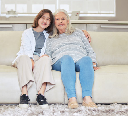 She loves her granny. Shot of a mature woman bonding with her grandchild on a sofa at home.の写真素材