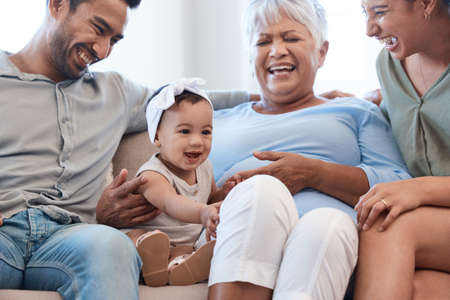 Causing quite a stir. Shot of a family spending time together on a sofa at home.
