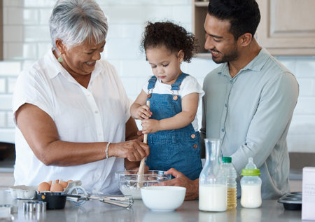I even taught your dad this recipe. Shot of an adorable little girl baking with her father and...