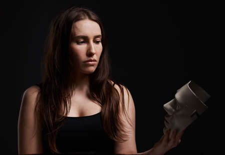 Ill no longer be controlled. Studio shot of a woman holding a mask.の写真素材