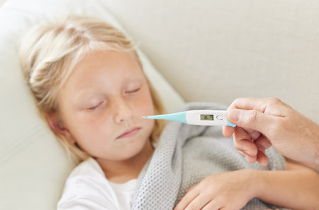 Shot of an unrecognizable male doctor taking a little girls temperature at home.