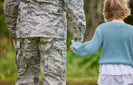 Love, honesty, and connection are cultivated in a family. Shot of a unrecognizable man holding his daughters hand outside.の写真素材
