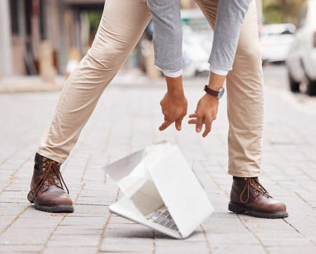 Shot of an unrecognizable businessperson dropping a laptop on the floor.の写真素材