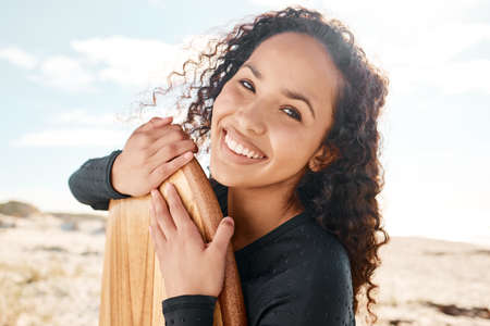 Were all equal before a wave. Shot an attractive young woman posing with her surfboard and going out...