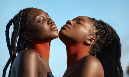 In touch with their values. Shot of two beautiful tribal women posing outside together.の写真素材