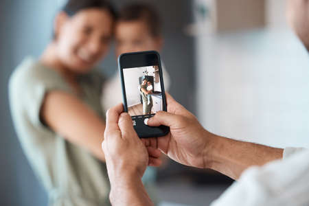 Shot of a young mother taking a picture with her baby at home.