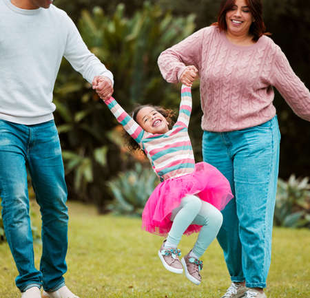 I love my mom and dad. Shot of a little girl having fun with her parents outside.の写真素材
