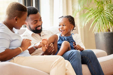 She lights up our lives. Shot of a family spending time together at home.