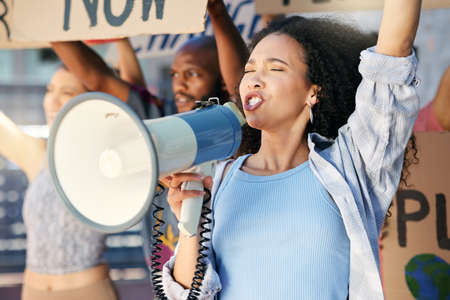 Taking a stand. Cropped shot of a group of young people protesting in the city.