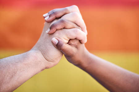 We want the best for one another. Shot of two protestors joining hands in unity during a protest.の写真素材