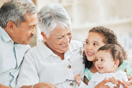 Real, raw love. Shot of grandparents bonding with their grandchildren on a sofa at home.