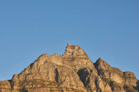 Copyspace with scenic landscape of a mountain peak against a clear blue sky on a sunny day. Scenic...