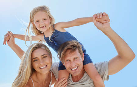 Portrait of a happy family having fun together with copyspace. Young smiling parents enjoying...
