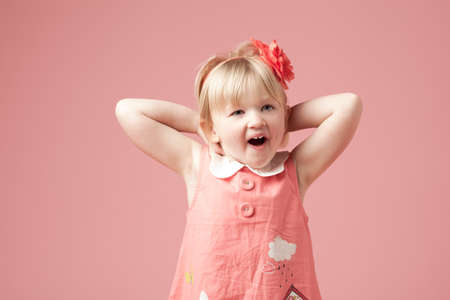 Cant wait to see what it is. Shot of a cute little girl against a studio background.の写真素材