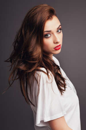 Feeling fierce and beautiful. Shot of a beautiful young woman posing against a studio background.の写真素材