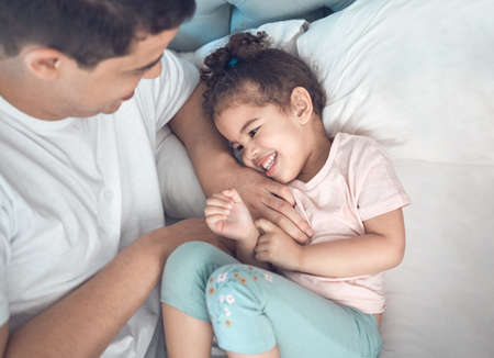 She is my bigger picture. Shot of a dad and daughter bonding in bed together.の写真素材