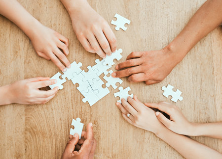 Family wars. Shot of a family building a puzzle together at home.