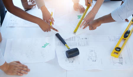 Planning big things. High angle shot of a group of businesspeople drawing up a plan at work.