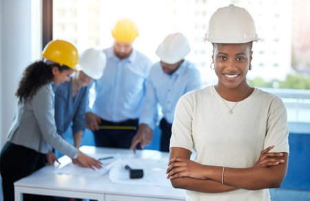 Designing the city. Shot of a young businesswoman standing with her arms crossed in an office at...