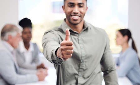 Expect nothing but the best from him. Portrait of a young businessman showing thumbs up in an office...
