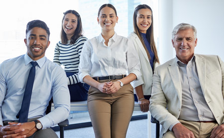 Their services come highly recommended. Shot of a group of businesspeople posing together in an office.の写真素材