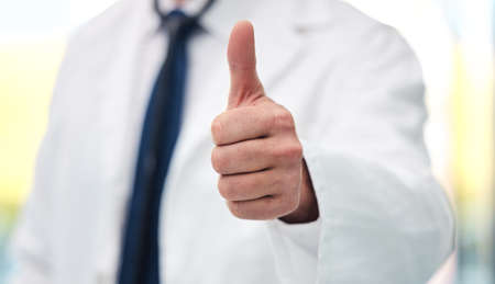 I can help you with any issue. Shot of an unrecognizable doctor showing a thumbs up at a clinic.の写真素材