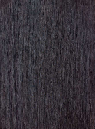Close up of a section of glossy straight brown hair. Showing hair treatment results after keratin...