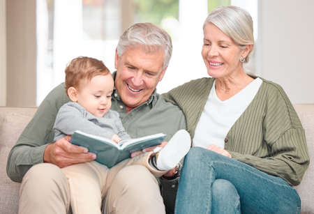 Spending time with granny and grandpa. Cropped shot of an affectionate senior couple reading to...
