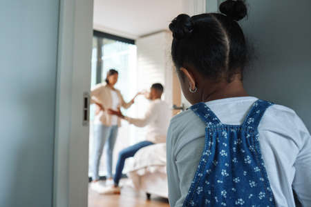 Temptation is taking a short cut. Shot of a little girl watching her parents argue at home.の写真素材