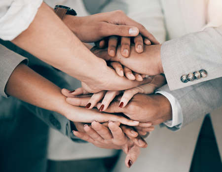 Weve got all the motivation we need. Shot of a group of unrecognizable businesspeople stacking their...
