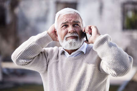 Does God have a number. Shot of a man calling for help after losing his home to a fire.の写真素材